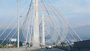 El Poblado and suspension bridge over Medellin river in Medellin photo