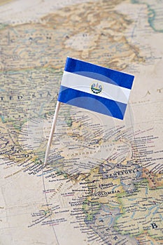 El Salvador flag pin on a world map photo