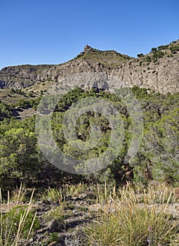 El Santo Peak on a hot April afternoon, seen from the trail to its summit under a bright blue sky. photo