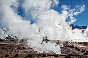 El Tatio geysers in Chile, Silhouettes of tourists among the steams and fumaroles