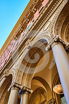 Elaborate carvings on underside and side of building with tall pillars