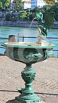 Elaborate green drinking fountain with dragon spout