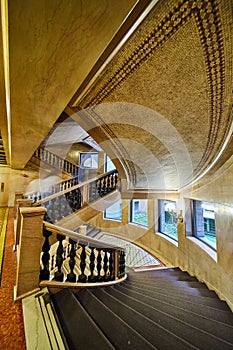 Elaborate winding staircases with multiple levels and curved wall with windows