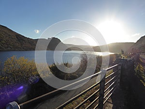 Elan Valley reservoirs, Wales with sun going down in blue skies photo