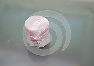 Elastic roll gauze bandage hold in hand with adhesive for first aid compress care for accident on table top view