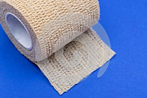 Elastic Self-Adhering Compression Bandage Cohesive Bandage on blue