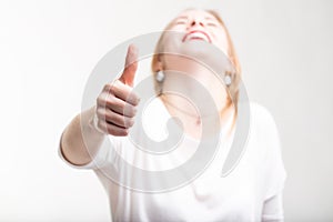 Elated excited woman giving a thumbs up