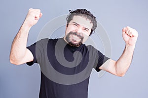 Elated man with fists held up