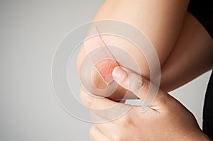 Elbow with adhesive bandage