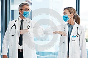 Elbow greeting, doctors and medical healthcare workers with covid 19 virus safety masks in a hospital portrait. Life