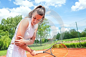 Elbow injury in tennis, unpleasant facial expression photo