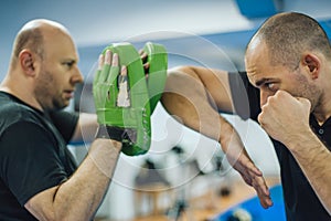 Elbow kick technique training with focus mitts. Elbow strike and punch