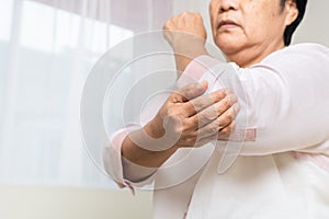 Elbow pain old woman suffering from elbow pain at home, healthcare problem of senior concept