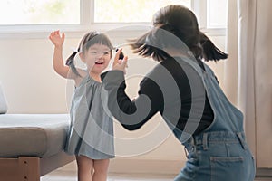 Elder asian sister play and dance with younger asian sister, Happy childhood