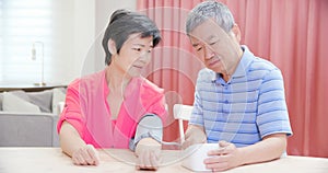 Elder couple use blood manometer