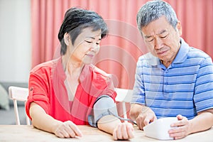 Elder couple use blood manometer