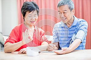 Elder couple use blood manometer