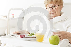 Elder eating meal at hospital