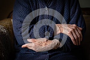 Elder grandmother woman crossing her wrinkled beautiful hands. Aging human process