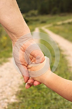 Elder hand holding youth hand photo
