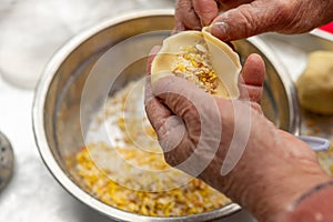 an elder lady making Guangdong-style crispy pastry dumplings for Chinese New Year photo