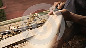 Elder man hand use knife cutting bamboo craftman work in Thailand