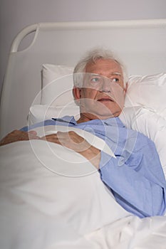 Elder man in hospital bed