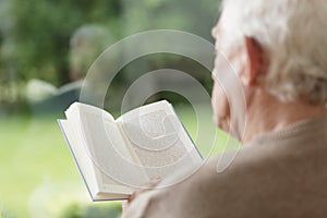 Elder man reading book
