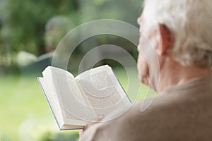 Elder man reading book photo