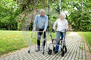 Elder man and a elder woman strolling in the park photo