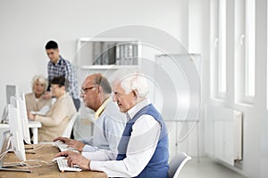 Elder men using computers