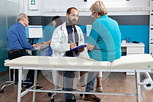 Elder patient discussing with doctor about osteopathy