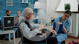 Elder patient talking to nurse for healthcare consultation