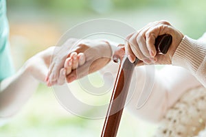 Elder person using walking cane