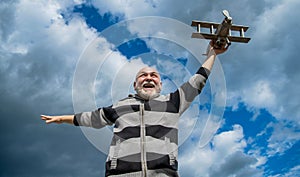 elder senior man on sky background. senior man at retirement. senior retired man with toy plane