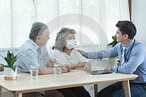 Elder senior old asian couple meeting  specialist professional caucasian doctor visit at home consultant two retirement patient