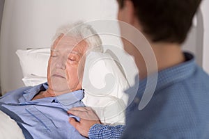 Elder sick man sleeping photo