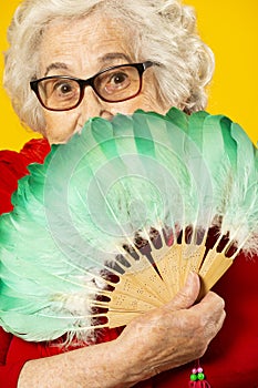 Elder woman with a green hand fan