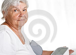Elder woman measuring blood pressure