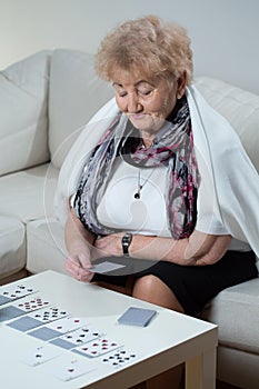 Elder woman playing solitaire