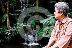 Elder woman resting in garden. elderly female relaxing outdoors. senior leisure lifestyle