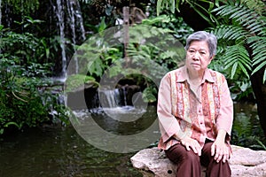 Elder woman resting in garden. elderly female relaxing outdoors. senior leisure lifestyle