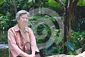 Elder woman resting in garden. elderly female relaxing outdoors. senior leisure lifestyle
