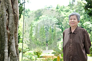 Elder woman resting in garden. elderly female relaxing outdoors. senior leisure lifestyle