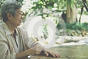 Elder woman resting in garden. elderly female relaxing outdoors. senior leisure lifestyle