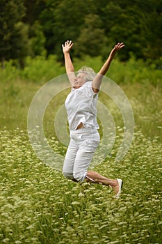 Elder woman smiling and jumping