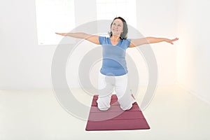 Elder woman working out on mat