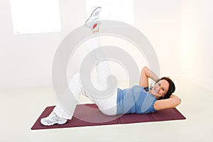 Elder woman working out on mat