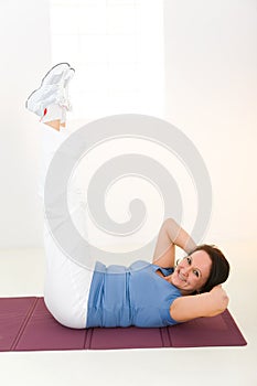 Elder woman working out on mat