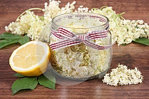 Elderberry flowers and lemon for preparing fresh healthy juice on board, concept of alternative medicine